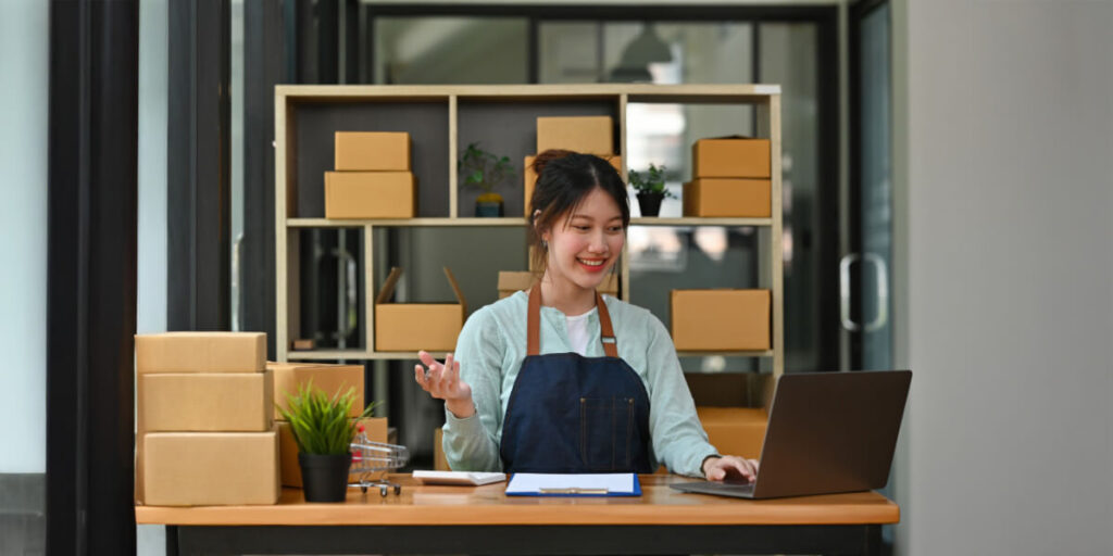 Small business owner analyzing digital marketing results across multiple devices with sales graph showing upward trend. Small business owner analyzing digital marketing results across multiple devices with sales graph showing upward trend.