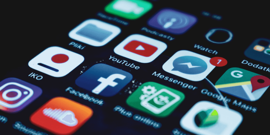 Mobile phone displaying social media apps like Instagram, LinkedIn, and Facebook in 2025